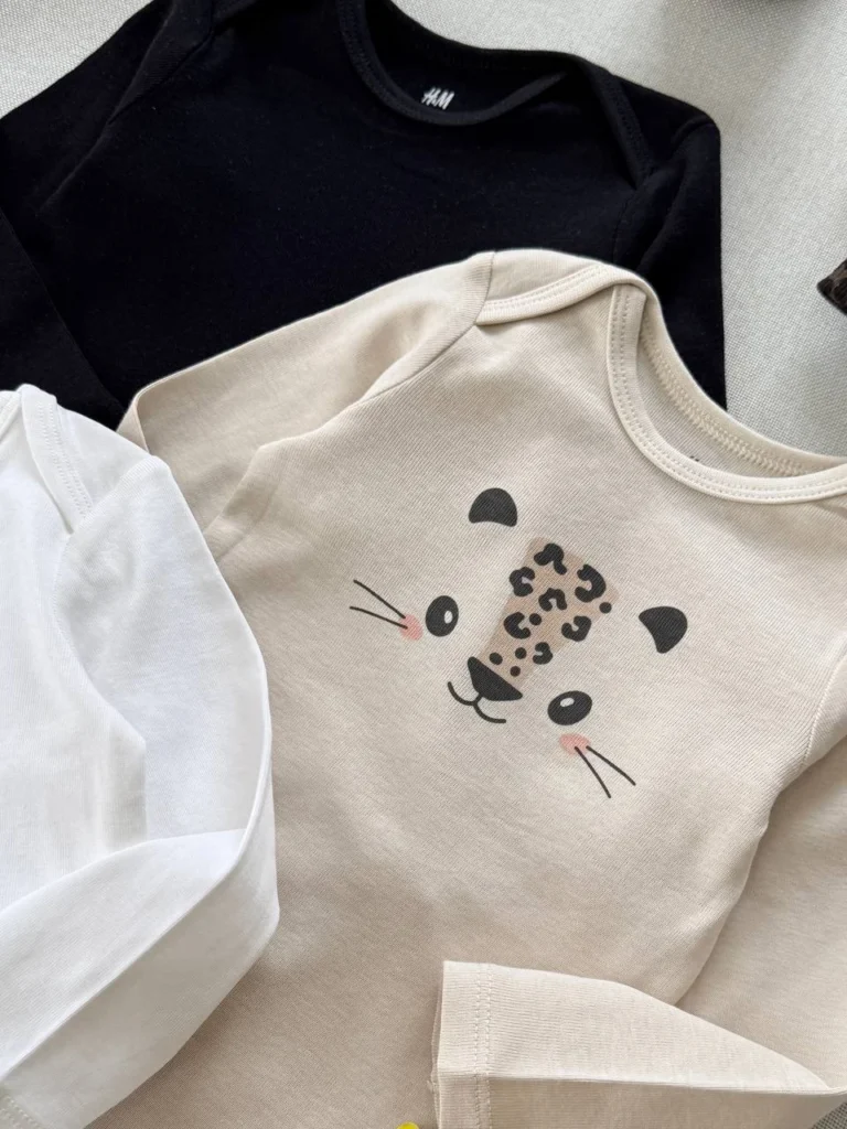 بادی نوزادی آستین بلند H&M با طرح صورت حیوان (هاپو) و رنگ کرم