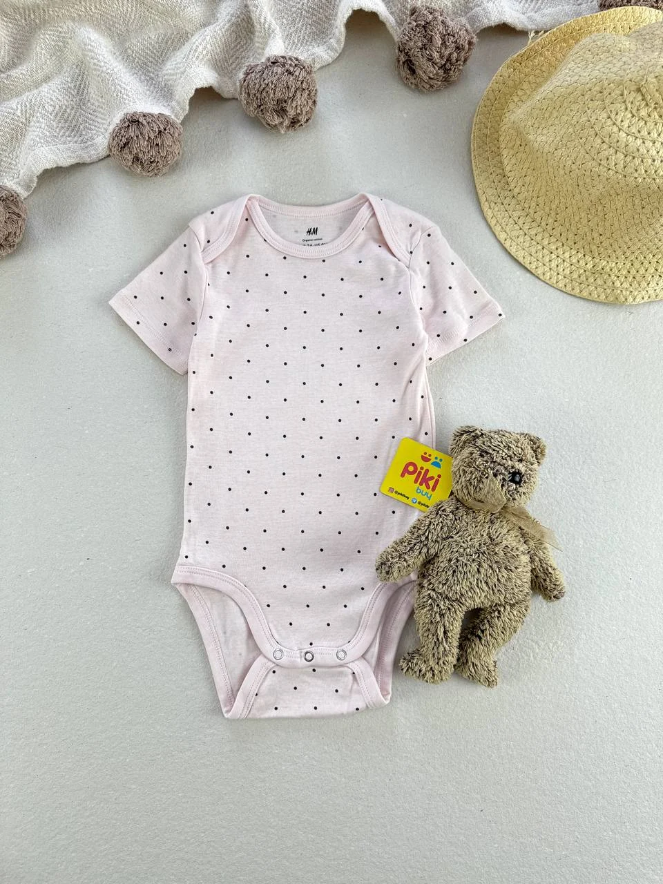 5791854070170586880 بادی آستین کوتاه برند H&M زمینه صورتی خالدار 6-9 ماه - Image 1